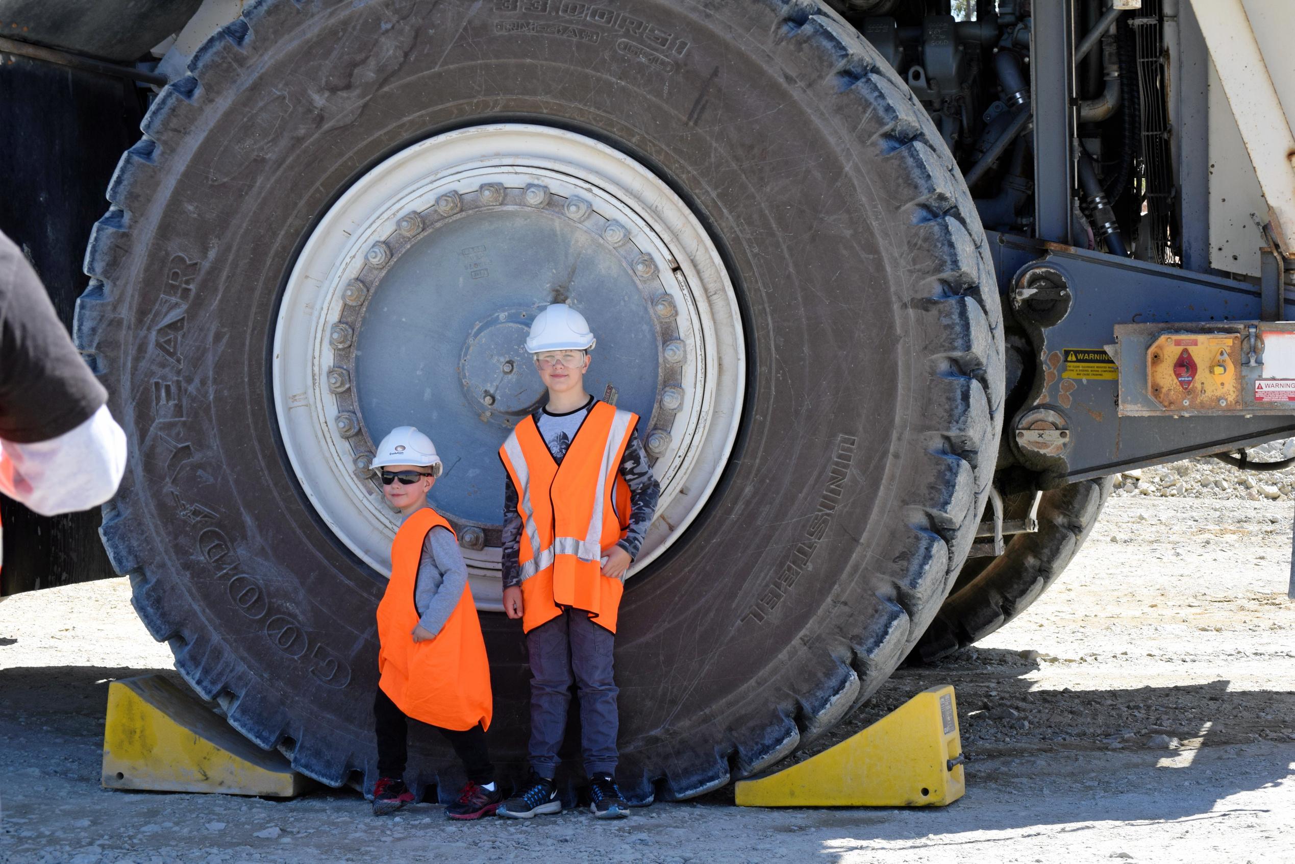 Xavier and Coby Johnson in front of one of the dump trucks. Picture: Marissa Newman