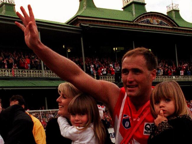 JUNE 6, 1999 : Tony Lockett with wife Vicki & daughters Courtney & Chloe during lap of honour around SCG in 1963 Cadillac after he broke record of 1300 goals set by Gordon Coventry in 1937, during Sydney Swans v Collingwood AFL game, 06/06/99. Pic Trent Parke Australian Rules Lock/fam