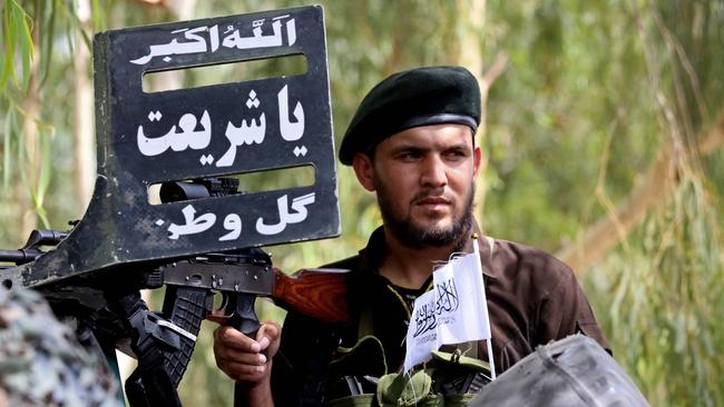 A Taliban security personnel stands guard at a checkpoint in Jalalabad.