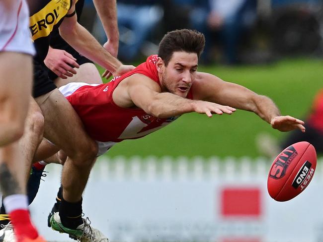 11/06/18 - SANFL match between Glenelg and North Adelaide at Glenelg Oval.  North's Aidan Tropiano dives for the ball. Picture: Tom Huntley