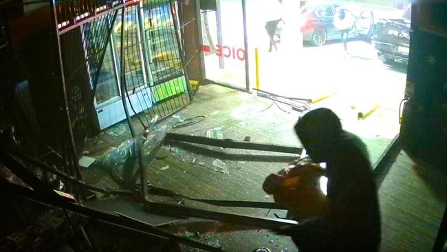 Video footage shows the gang of hooded youths inside the Daisy Hill tobacco shop. Pictures: QPS