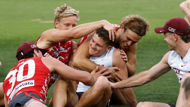 ** Embargo - 11.45 am today ** - Tom Hanily is congratulated after receiving the news from coach Dean Cox at training on Wednesday night that he will make his debut for the Swans against Hawthorn in the AFL Opening Round. Photo by Phil Hillyard (Image Supplied for Editorial Use only - **NO ON SALES** - Â©Phil Hillyard )