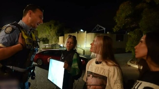 Ms Peterson talks to an attending police officer at the scene. Picture: 9 News