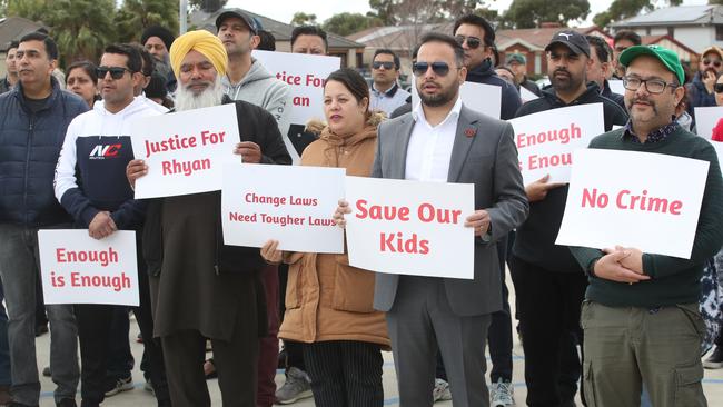 Those in attendance held up signs calling for an end to youth crime. Picture: David Crosling