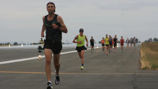 Runners put the Launceston Airport runway to good use in the absence of any flights. Picture: Supplied