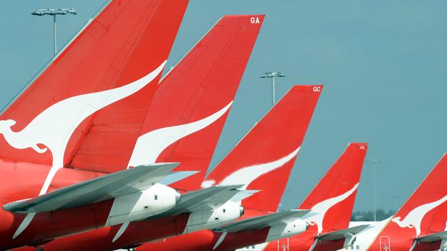 **FILE** A Dec. 3, 2008 file photo of the tails of Qantas jets at Sydney International Airport. Qantas Airways Ltd's first-half profit slumped 66 per cent, Wednesday, Feb. 4, 2009, as fuel and labour costs buffeted Australia's biggest airline. (AAP Image/Dean Lewins,File) NO ARCHIVING