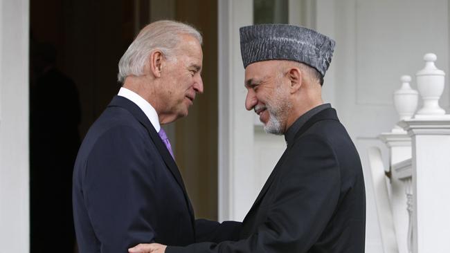 Afghanistan’s former President Hamid Karzai (R) is welcomed by then US Vice President Joe Biden for dinner at his official residence on the grounds of the Naval Observatory in Washington in 2010.