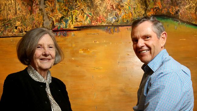 Fred Williams’ widow Lyn with Philip Bacon from Philip Bacon Galleries in front of the painting Forest Pond, which fetched a record price. Picture: AAP/Darren England