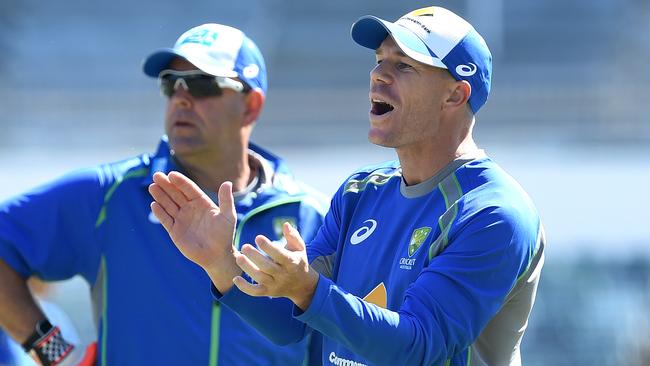 David Warner looks on with coach Darren Lehmann.