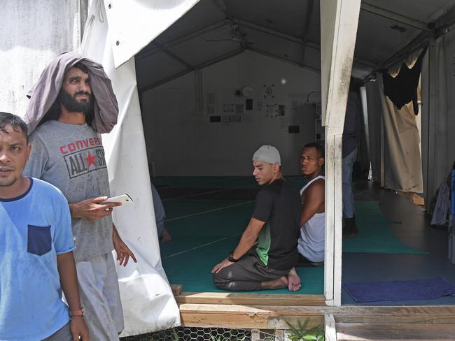 Asylum seekers pray at the abandoned detention centre. Picture: Brian Cassey