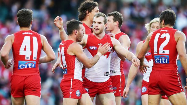 Tom Mitchell celebrates a goal with teammates.