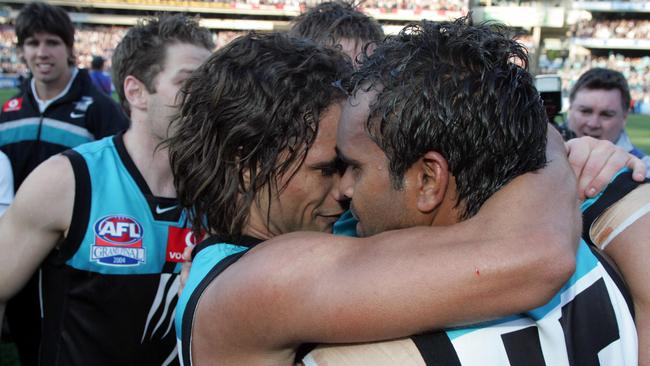 Close mates Peter Burgoyne and Byron Pickett hug after the grand final.