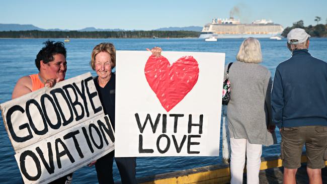 Rosalee Hunter, far left, and Lorraine Trivett farewell Ovation of the Seas as the cruise liner leaves New Zealand’s port of Tauranga on Wednesday. Picture: Adam Yip