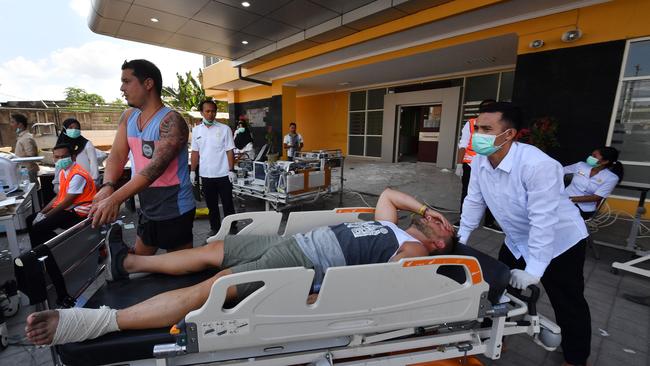 An injured foreign tourist receives medical attention at a makeshift unit. Picture: AFP