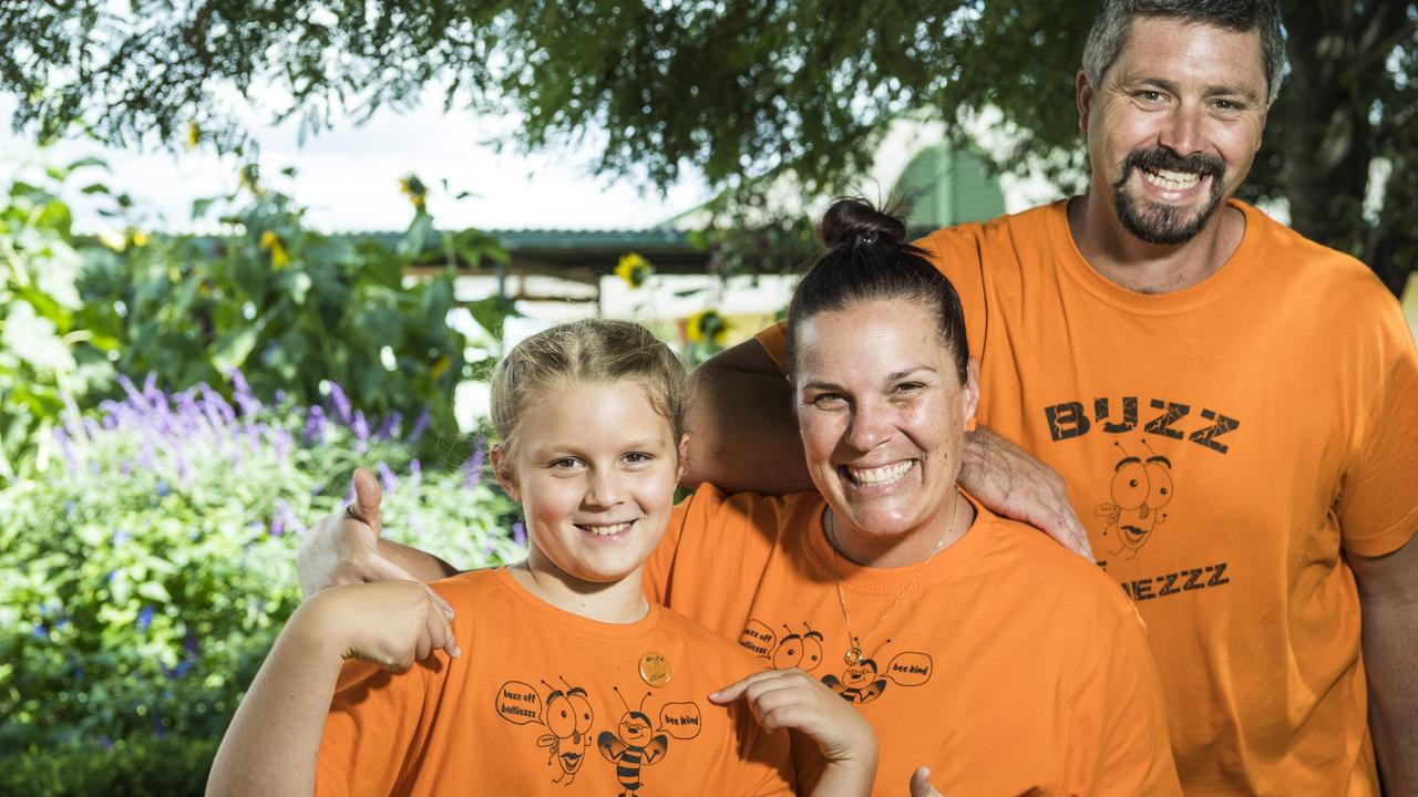 Fairview State School student Olivia Gollan shows off her t-shirt created for the National Day of Action against Bullying and Violence, with support from her parents Tracey and Marshall. Picture: Kevin Farmer