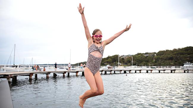 Chloe Brown, 8, went down to Balmoral Beach for an early morning swim with her mother Saskia. Picture: Adam Yip