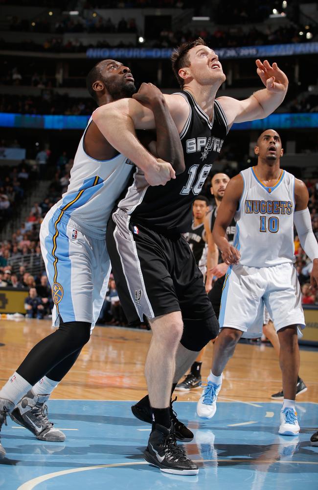 Aron Baynes #16 of the San Antonio Spurs battles for position against J.J. Hickson #7 of the Denver Nuggets.