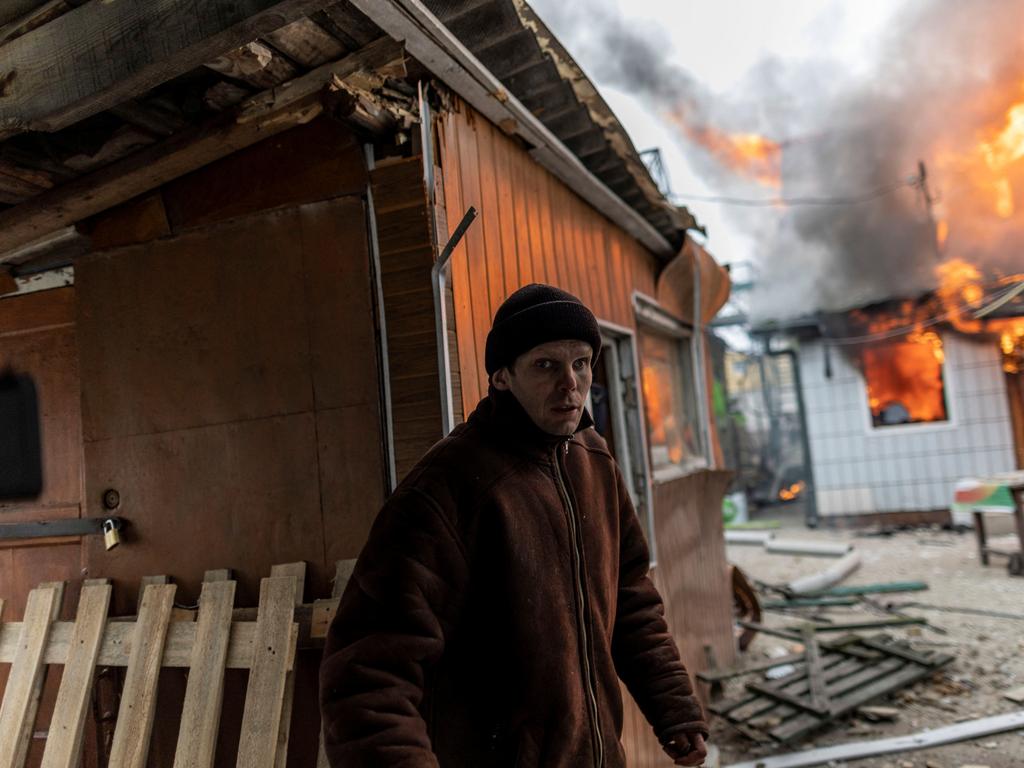 A local resident reacts as a house is on fire after heavy shelling on the only escape route used by locals to leave the town of Irpin. Picture: Reuters