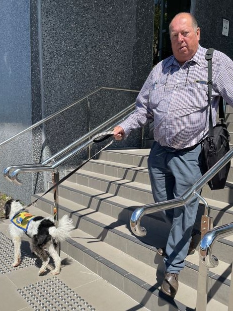 Peter George Reurich leaves Taree court with a support dog on December 5.