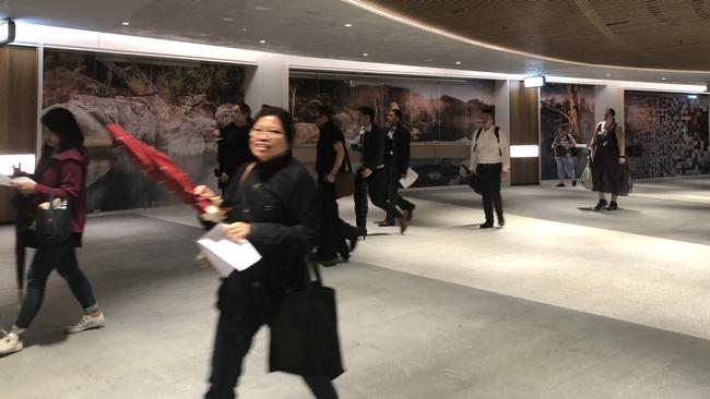 The first group of commuters to walk through the Parramatta Square underground link during the morning peak hour.