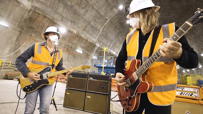 Powderfinger guitarists Darren Middleton and Ian Haug play songs in the Cross River Rail tunnel where Albert Street Station will be.