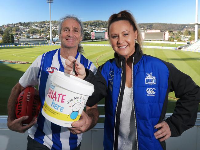 Dave Noonan and Al Plath ready to collect donations at a North Melbourne match at Blundstone Arena in 2017. Picture: LUKE BOWDEN