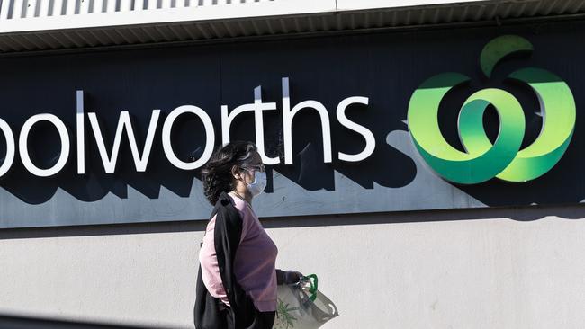 A sign of the times: a masked shopper at a Woolworths supermarket. Picture: Getty Images