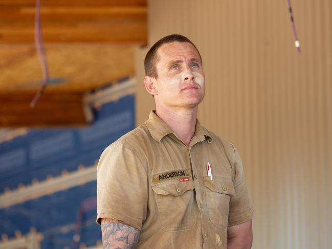 ADF sapper Selwyn Anderson stands under the roof of the independent Youth Centre he and his team have been working on. Picture: Floss Adams.