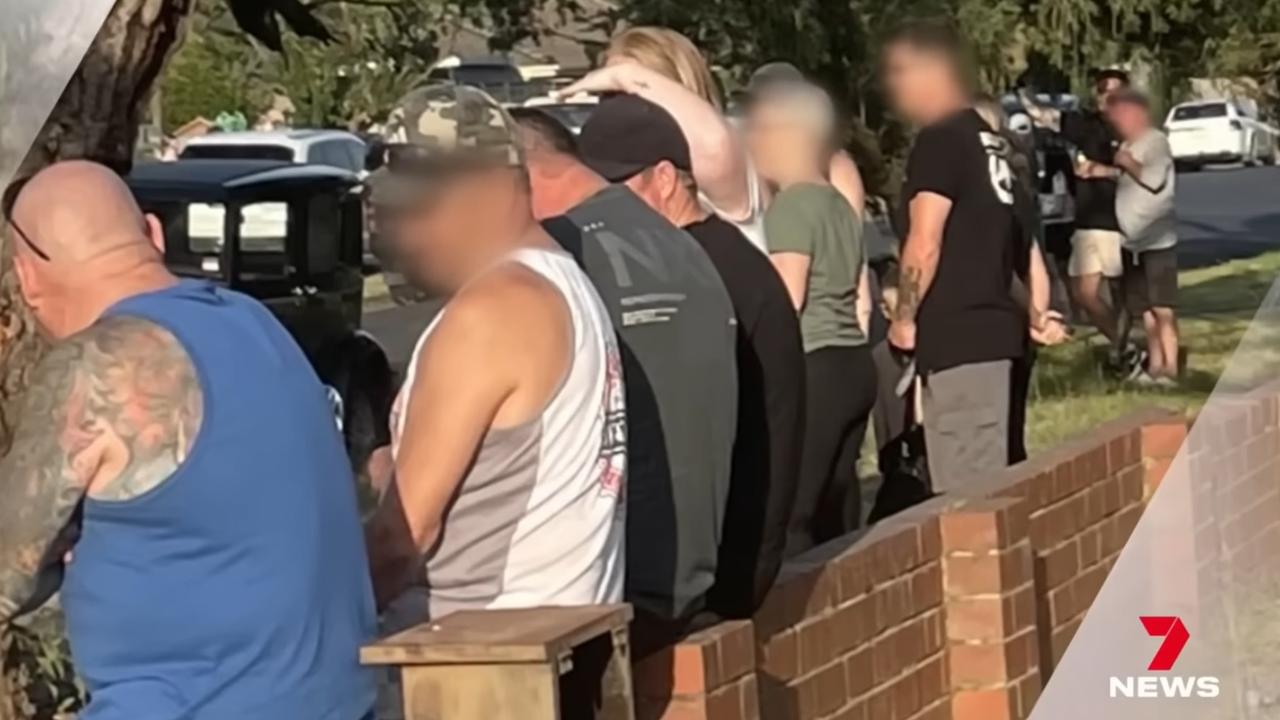 Fed-up parents stand guard outside home