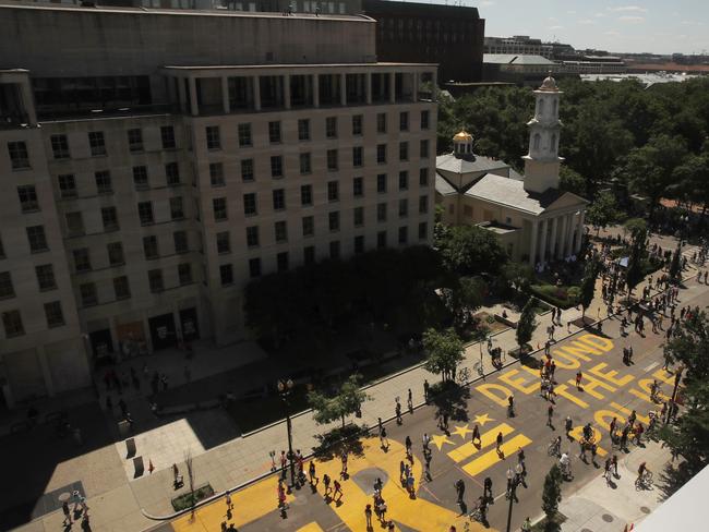 The words “defund the police” have been painted in bright yellow near the White House. Picture: AP