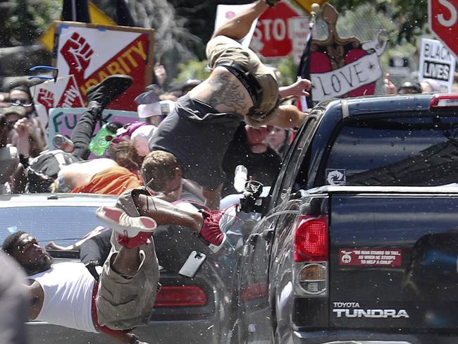 Marcus Martin (left) was one of a number of people to be hit when a vehicle drove into a group of protesters demonstrating against a white nationalist rally in Charlottesville. Picture: Ryan M. Kelly/The Daily Progress via AP