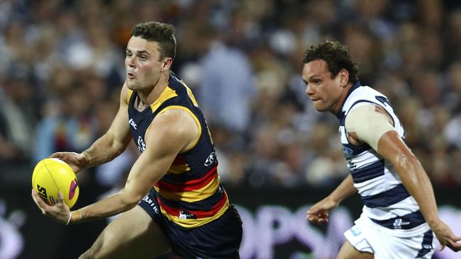 Brad Crouch sprints away from Steven Motlop during the preliminary final. Picture: Sarah Reed