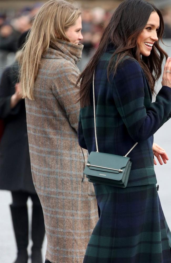 Meghan Markle carried another Strathberry bag — this time, a green cross-body bag. Picture: Getty