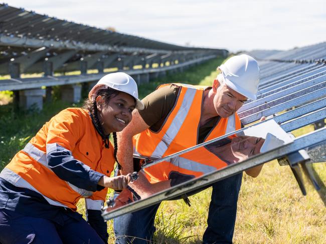 Senior Engineer and Aboriginal Australian Apprentice Working Together On Solar Farm Installation