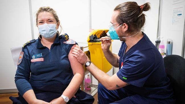 Paramedic Shelly Tennant is among a majority of ambos to roll up their sleeves and get the Covid jab. Picture: Mark Stewart