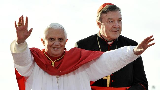 Pope Benedict XVI, left, waves as walks to the stage with Cardinal George Pell, in 2008. Picture: AP