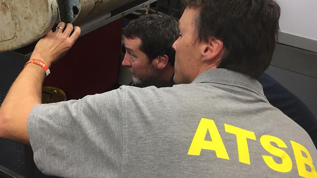 Australian investigators in Canberra examine a piece of aircraft debris found on Pemba Island off the coast of Tanzania.