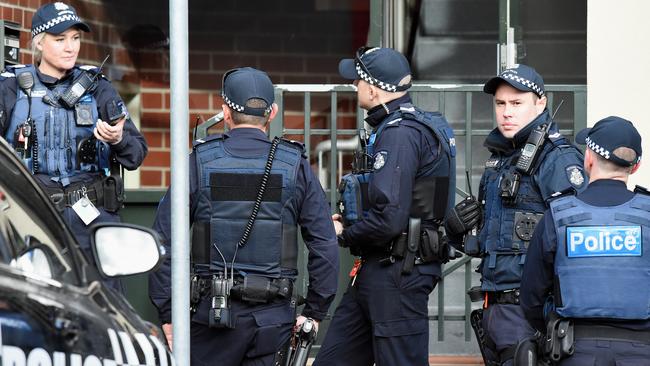 Police swarm the Viscount apartment block during the operation. Picture: Lawrence Pinder