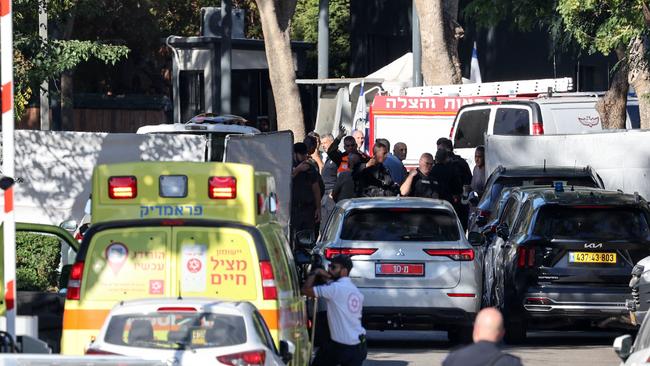 An ambulance can be seen as security forces wallow a car to cross a barrier along a street leading to Prime Minister Benjamin Netanyahu's residence in Caesarea. Picture: AFP