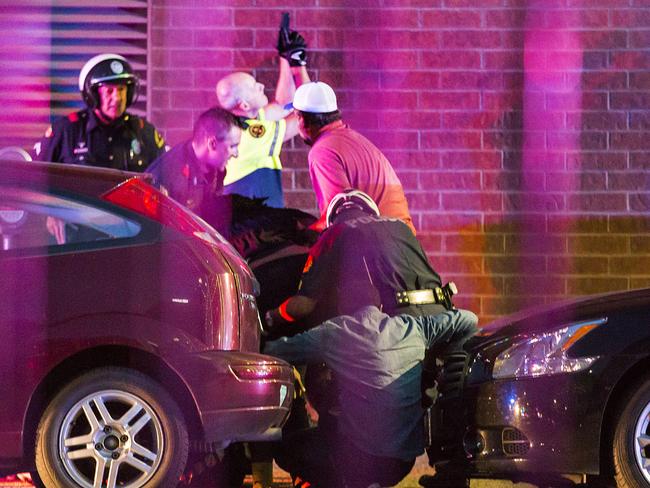 Dallas Police shield bystanders after shots were fired Thursday. Picture: Smiley N. Pool/The Dallas Morning News via AP