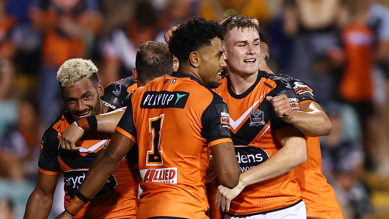 The Tigers celebrate a try by Alex Seyfarth against the Sharks at Leichhardt Oval. (Photo by Jeremy Ng/Getty Images)