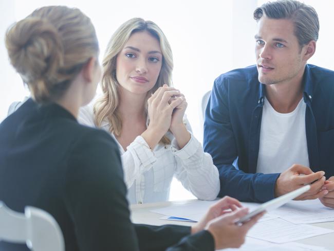 A couple discussing their home loan with a mortgage broker. Picture: iStock.