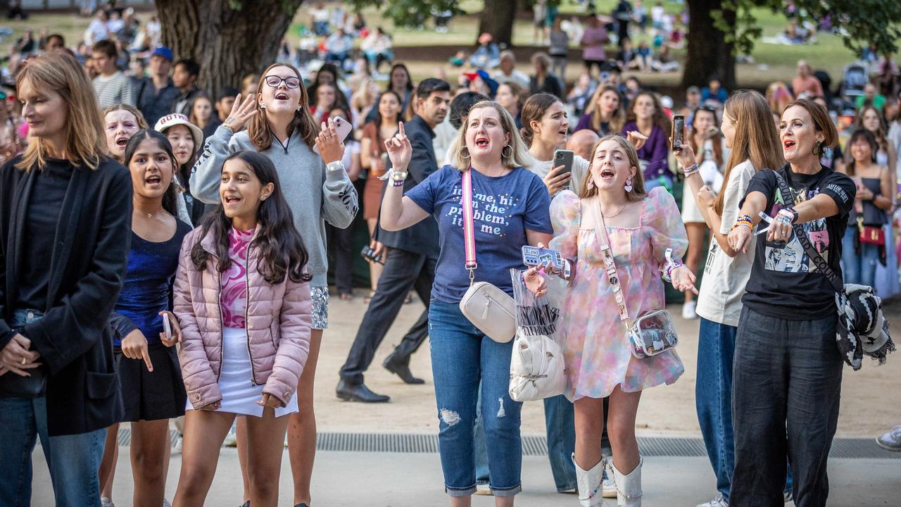 Fans enjoy the concert from outside the MCG. Picture: Jake Nowakowski