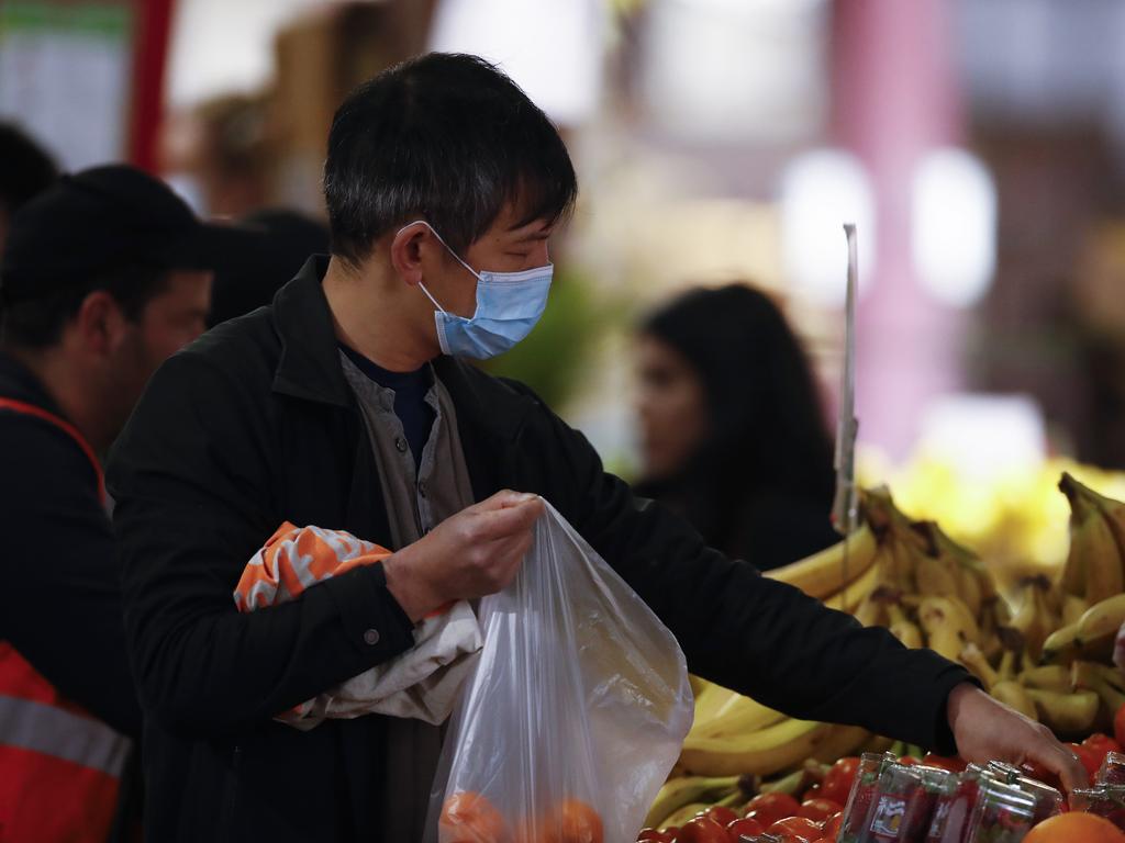 People are seen wearing masks at the Queen Victoria Market in Melbourne. Picture: NCA NewsWire/Daniel Pockett