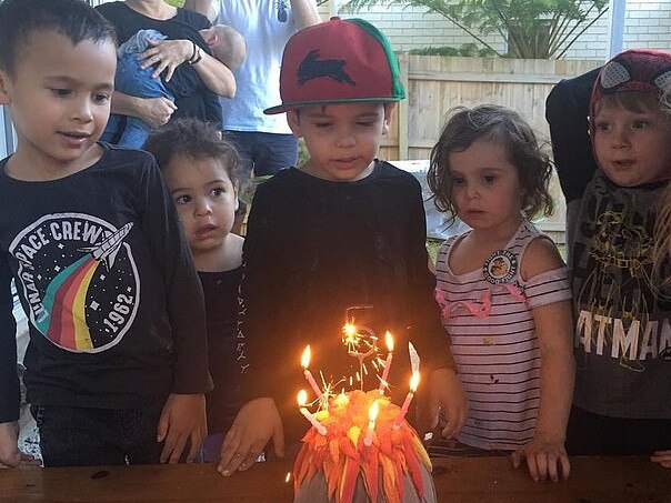 Greg Inglis' estranged wife Sally, posted an innocent of her son Nate (centre) standing before a birthday cake surrounded by friends before it was set upon by trolls