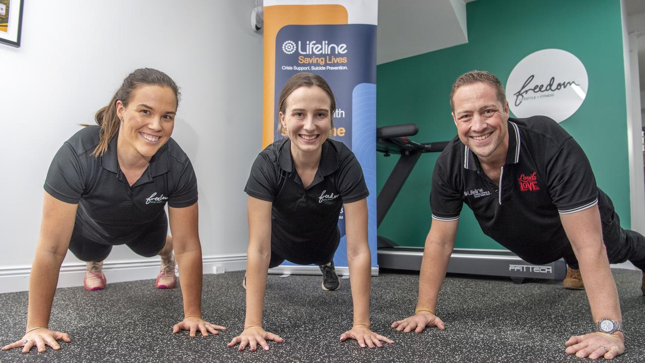 PUSH IT: Nicole Steffens and Layla Millington from Freedom Lifestyle and Fitness join Matt Gregg from Lifeline for a quick workout during the Lifeline Darling Downs launch for The 2021 Push-Up Challenge. Picture: Nev Madsen