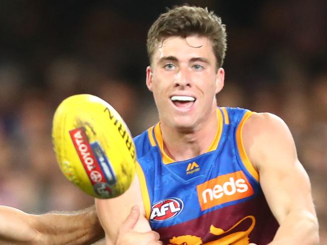 BRISBANE, AUSTRALIA - AUGUST 04: Noah Answerth of the Lions handballs during the round 20 AFL match between the Brisbane Lions and the Western Bulldogs at The Gabba on August 04, 2019 in Brisbane, Australia. (Photo by Chris Hyde/Getty Images)