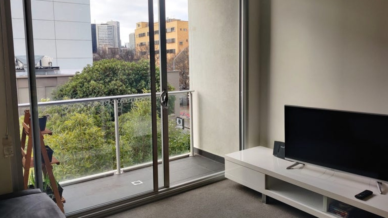 A private balcony offers views across the city and beyond.