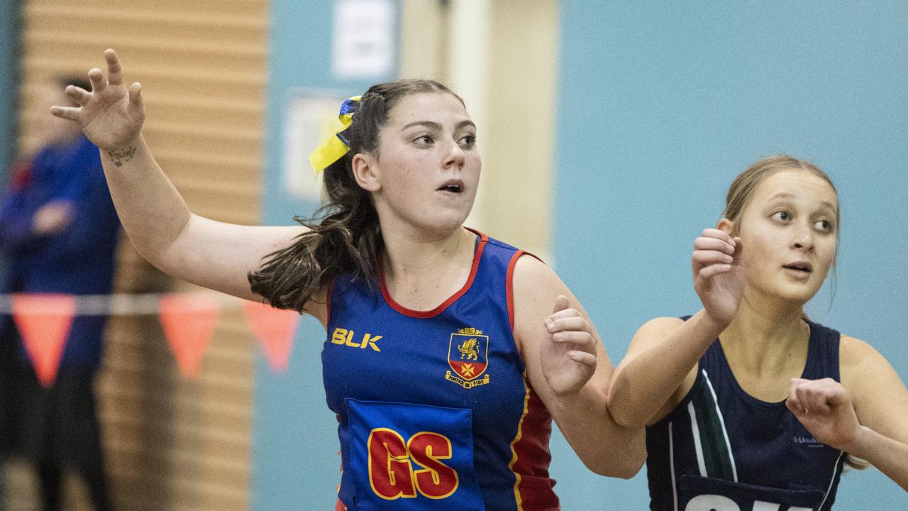 Caitlin O'Neill (left) of Downlands Junior A and Maya Cameron of St Ursula's Junior A in Merici-Chevalier Cup netball at Salo Centre, Friday, July 19, 2024. Picture: Kevin Farmer