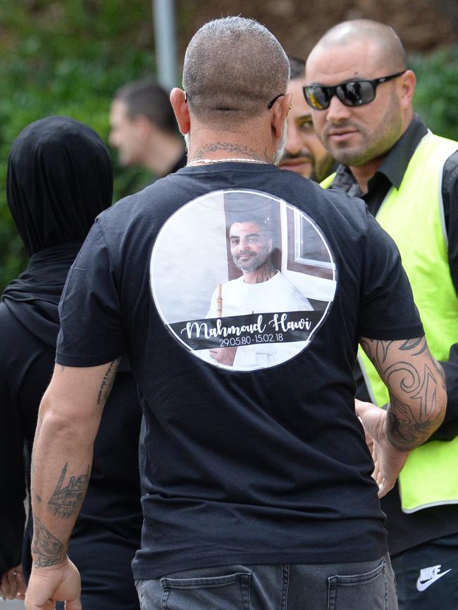 A mourner at Mahmoud Hawi’s funeral wearing a shirt bearing his face. Picture: Jeremy Piper